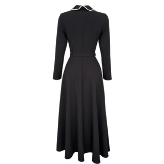 BLACK DRESS WITH PEARL EMBELLISHED COLLAR AND ASYMMETRICAL SKIRT.